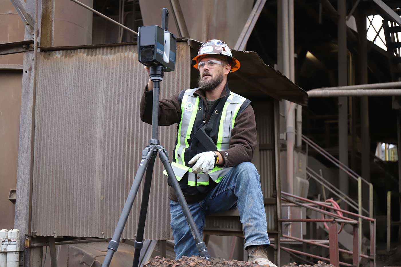 3D laser scanning camera being operated by a technician on a jobsite
